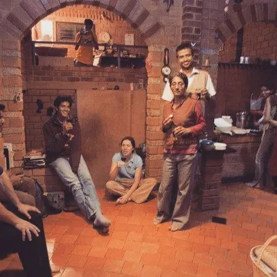 A photo from our archives, showing our young team sharing a meal in the basement office of our founder's home. Even in our earliest days, our conversations were always about design, water, and building a better world.