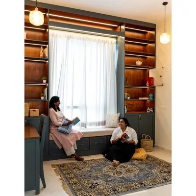 We transformed this staircase landing into a cozy library and reading retreat. The floor-to-ceiling bookshelves are built around a large window, which features a comfortable window seat with integrated drawers for extra storage.
