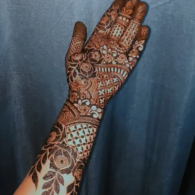 A beautiful floral henna design with a mix of bold and fine lines.