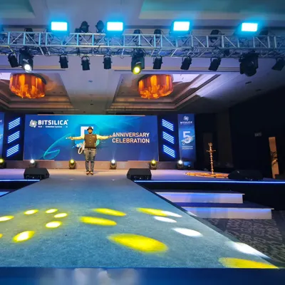 A clean, professional setup for a corporate anniversary celebration. The stage features a large LED screen for branding and presentations, flanked by a powerful sound system, all designed to create a premium awards night experience.