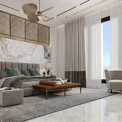 This master bedroom is a sanctuary of style, featuring a stunning headboard wall that combines book-matched marble with brass-inlaid geometric paneling. The floor-to-ceiling windows, dressed in sheer curtains, fill the room with soft, natural light.