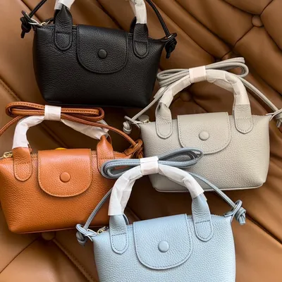 All the lovely colours of the Metro Mini bag, inspired by the Longchamp mini. You can see the black, brown, grey, and light blue options, all made from quality pebbled leather.