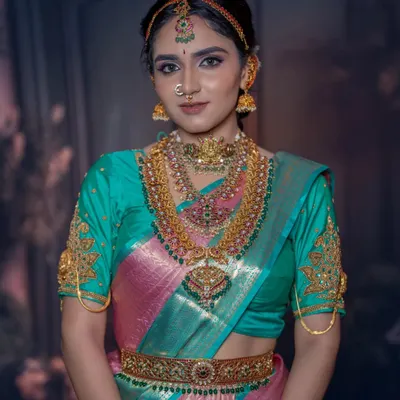 A complete South Indian bridal jewellery set featuring layered necklaces, a goddess-pendant choker, and matching jhumkas. This rental set provides a grand and traditional look.