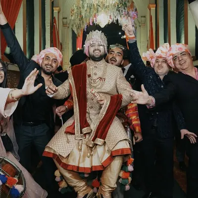 The groom's entry should be full of energy! This shot captures the groom enjoying his baraat, dancing with his friends and family. It's these high-energy, fun-filled candid moments that make a wedding album complete.