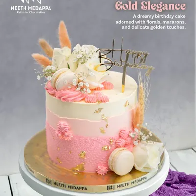 Blush and Gold Elegance. This dreamy birthday cake is adorned with fresh florals, delicate macarons, and touches of gold leaf for a soft, romantic feel.