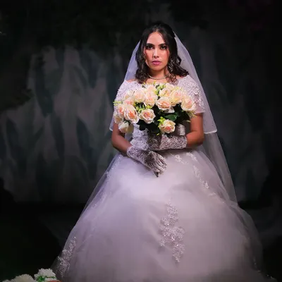 A beautiful Christian bride look, complete with a white ball gown, veil, gloves, and a bouquet of roses. I provide complete bridal packages for all cultures.