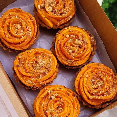 These mango tarts are to die for. I start with a buttery, crispy pastry shell, fill it with a dreamy creme patissiere and fresh mango puree, and top it with beautifully arranged fresh Alphonso mango slices and crunchy almonds.