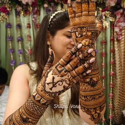 A stunning example of a full bridal design. Notice the personalized initial 'K' on the palm, a popular customization I teach students how to incorporate elegantly.