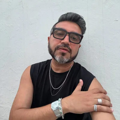 A close-up of my Mykonos look. The focus is on the accessories: layered silver chains, a statement watch, and bold rings that add a personal edge to a simple black outfit.