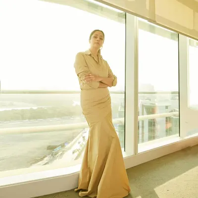 Jyotika in a sophisticated beige shirt-dress, a perfect example of understated elegance for a promotional event.