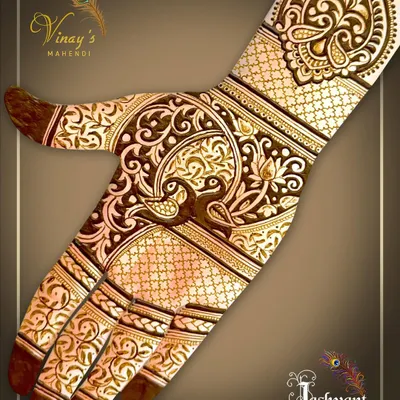 A beautiful back-of-hand design featuring a peacock as the central motif, surrounded by delicate floral vines and traditional jaal work.