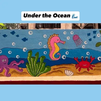 This cheerful underwater mural transforms a plain wall into an aquatic adventure, complete with a friendly crab, jellyfish, turtle, and seahorse.