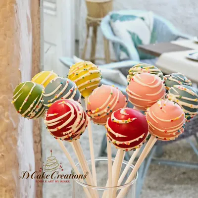 A bouquet of custom cake pops from Rochelle and Keith's "Ready to Pop" baby shower. We used a vibrant color palette of red, pink, yellow, and green to match the joyful, balloon-filled decor of the event.