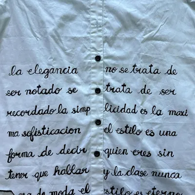 A closer look at the hand-painted calligraphy on one of the custom shirts. Each letter was carefully painted to create this beautiful text-based design, turning a simple shirt into a piece of wearable art.