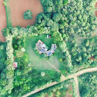 This C-shaped farmhouse is a prime example of innovative design. Its unconventional form is not just for aesthetics; it creates a sheltered central courtyard and maximizes views of the surrounding nature from every room.