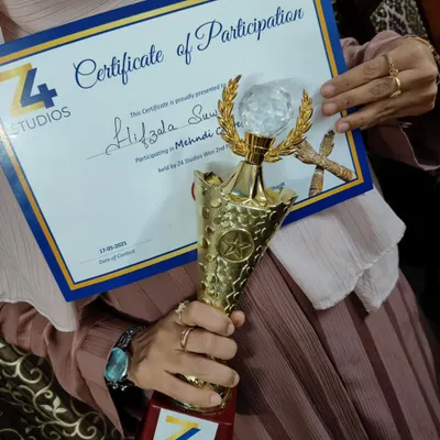 I am so proud to share my certificate of participation and trophy from a recent mehendi contest. It's an honor to be recognized for my passion.