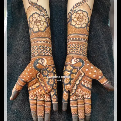 A beautiful design for a guest, featuring a combination of peacock and floral motifs. This style provides significant coverage on the hands while being less heavy than a full bridal design.