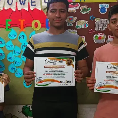 Celebrating our students' achievements. Three of our talented learners proudly holding their certificates after a successful performance.