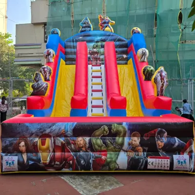 Here's a full view of our action-packed Avengers bouncy castle, ready for an outdoor event. With two slides and a central climbing ladder, it's designed to keep a whole team of superheroes entertained and active.