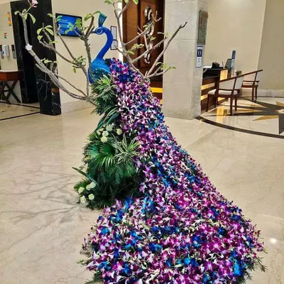 This magnificent peacock, with its tail flowing with thousands of fresh orchids, was a custom commission for a luxury hotel lobby. It demonstrates our ability to handle large-scale, highly artistic floral installations.