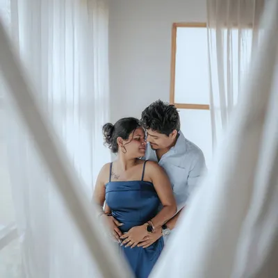 "Tum se." A beautifully framed, intimate portrait of a couple sharing a quiet moment indoors, with soft light filtering through the curtains.