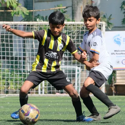 An intense moment from an SFL league match. Our player shields the ball, demonstrating the technical skills and composure we instill during training.