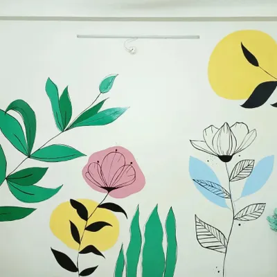 A section of a botanical wall mural I painted. This piece combines bold green leaves, abstract floral shapes, and line art to create a modern and vibrant feature wall.