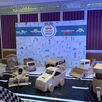 This is the complete 'Paint Shop' setup before the kids arrived. I provided a variety of unpainted cardboard vehicles, a custom backdrop, and a designated "road" for hours of creative fun and play.