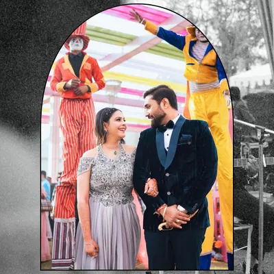 A wedding carnival brings a unique energy. We love capturing couples like Preetika and Rajveer amidst fun performers like stilt walkers, adding a touch of whimsy to their wedding album.