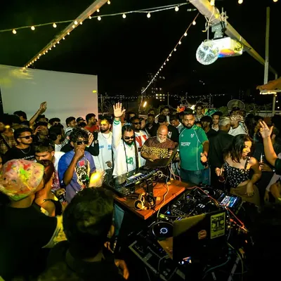 The view from behind the decks at my 'Block Party Vol. 1'. A packed rooftop, good music, and the whole community coming together.