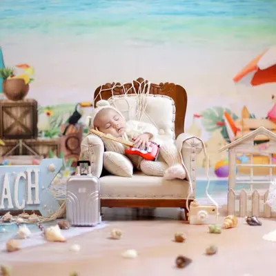 A full view of our elaborate beach vacation setup. This fun theme includes a miniature beach chair, suitcase, camera, and a vibrant seaside backdrop for a perfect getaway portrait.