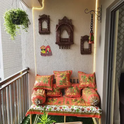 A full view of our Rajasthani-themed balcony design. The bright, block-printed fabrics on the bench and cushions, along with the carved wooden wall art, bring the culture of Rajasthan to this Bangalore home.