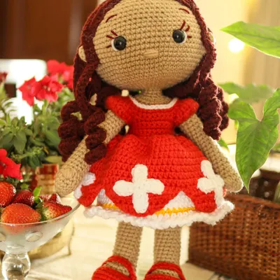 This is Lily, my first handmade doll, looking bright and cheerful in her red dress. She is designed without a smile to be a comforting friend who can share in any feeling your child has.