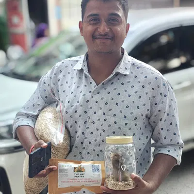 This happy customer just picked up a new hamster and all the supplies needed to get started, including hay and pellets. It's a joy to help new pet parents.