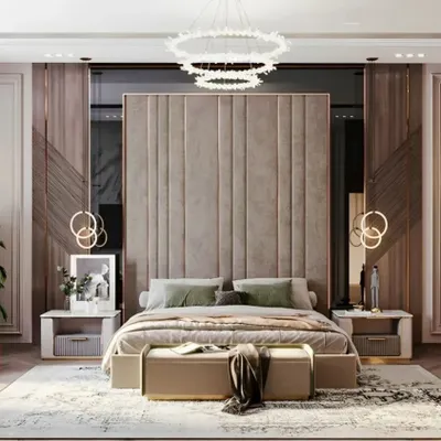 A truly grand master bedroom featuring a tall, upholstered headboard that makes a statement. I used elegant pendant lights and classic wall moulding to add a touch of timeless luxury to this residential interior design.