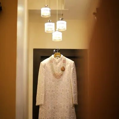 A perfect shot of the groom's wedding sherwani, elegantly displayed before the ceremony begins. Capturing the details of the attire is essential to telling the complete story of the day.