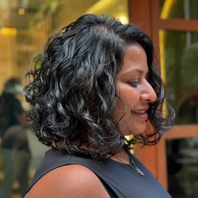 A classy curly bob is always a chic choice. This cut is perfect for giving fine or wavy hair more volume and shape.