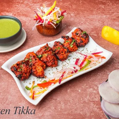 Our classic Chicken Tikka features boneless chicken pieces marinated in yogurt and spices, then grilled in the tandoor until tender and smoky. It's a timeless favourite.