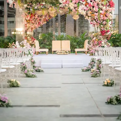 A closer look at our signature upside down garden installation. We meticulously arranged thousands of fresh flowers and elegant chandeliers to create a breathtaking canopy, making the wedding mandap feel like a scene from a dream.