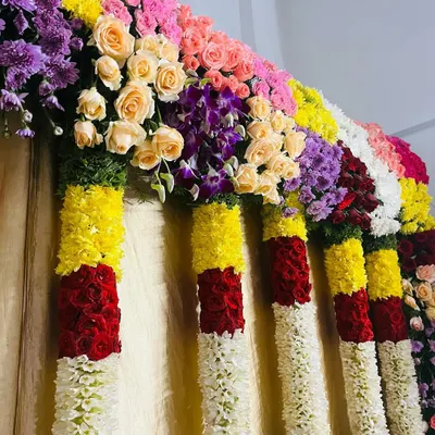 A close-up of a multi-colored floral border. You can see the variety of fresh flowers I use, including roses, chrysanthemums, and orchids, to create a rich and textured look.