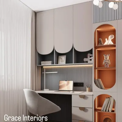 A modern and sleek study area. This design features custom overhead cabinets with curved details, built-in shelving with accent lighting, and a spacious desk, creating a sophisticated workspace.