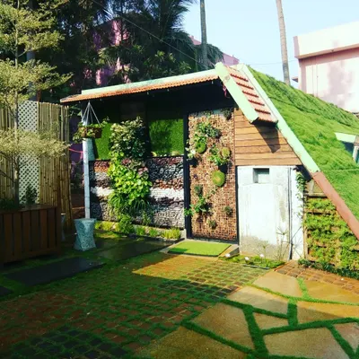 I love projects that let me get creative. Here, I designed and built a complete garden structure, featuring a living green roof, a mixed-material wall with stone and plants, and custom vertical planters.