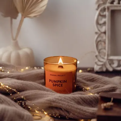 Creating a cozy autumn atmosphere for Mineral Project's Pumpkin Spice candle, using soft textiles and fairy lights to evoke warmth and comfort.