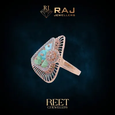 This bold cocktail ring features a striking combination of light blue and green stones, framed by an ornate, cage-like setting in rose gold. It is a true statement piece designed to capture attention.