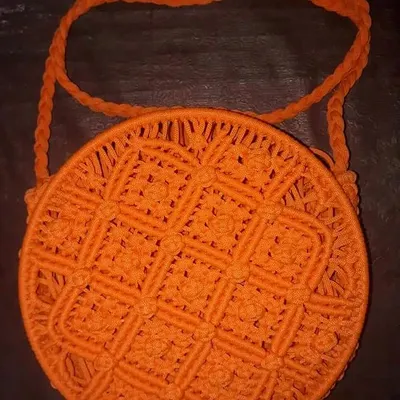 For those who want something a little different, I also make these Macrame Ring Bags. This one in bright orange has a unique circular design and intricate knotting, making it a real statement piece for any occasion. The braided strap is also handmade to match.