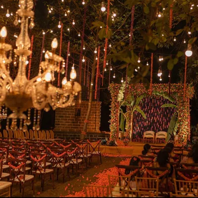 A magical mandap setting for a night ceremony. We used hundreds of marigold strings and hanging bulbs, complemented by ornate chandeliers, to create a warm, golden glow that felt both traditional and incredibly romantic.