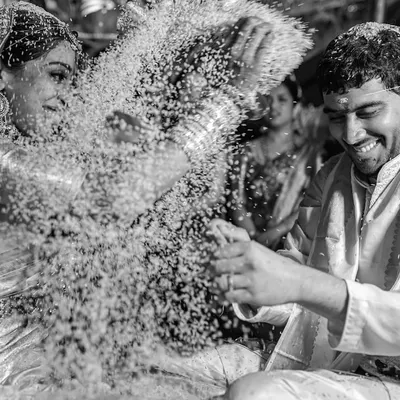 A playful moment during a South Indian wedding ritual as Sapni and Arjun shower each other with rice. We love capturing the fun and laughter that are woven into these sacred ceremonies.