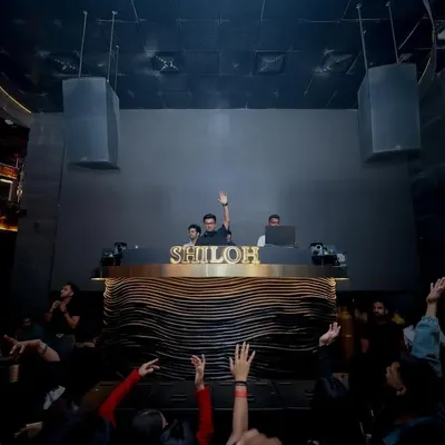 Commanding the console at Shiloh, one of Mumbai's premier clubs. A view from the dance floor as the crowd raises their hands to the beat.