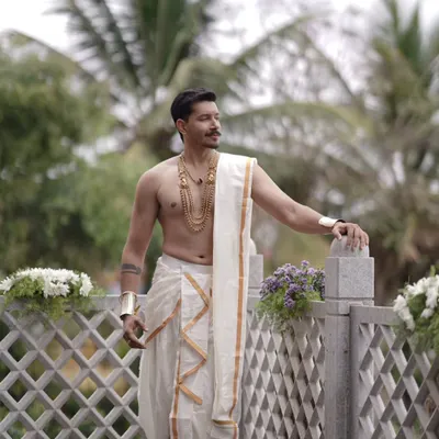 Here is a traditional muhurtham look for a groom. We styled him with a classic antique-finish layered necklace and matching arm cuffs to complete his veshti attire.
