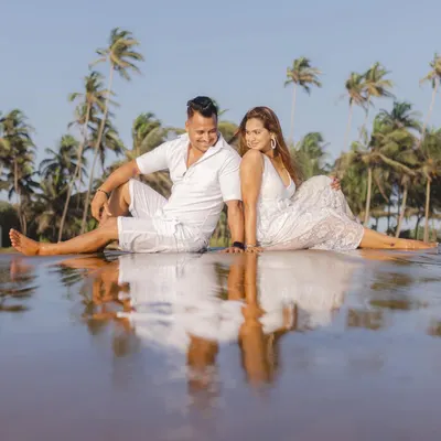 A perfect reflection. We found this spot with calm water on a Goan beach, creating a beautiful, symmetrical portrait of the couple against a backdrop of palm trees.